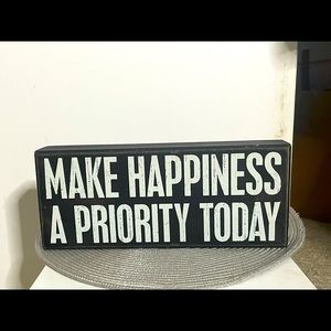 "Make happiness a priority today" box sign